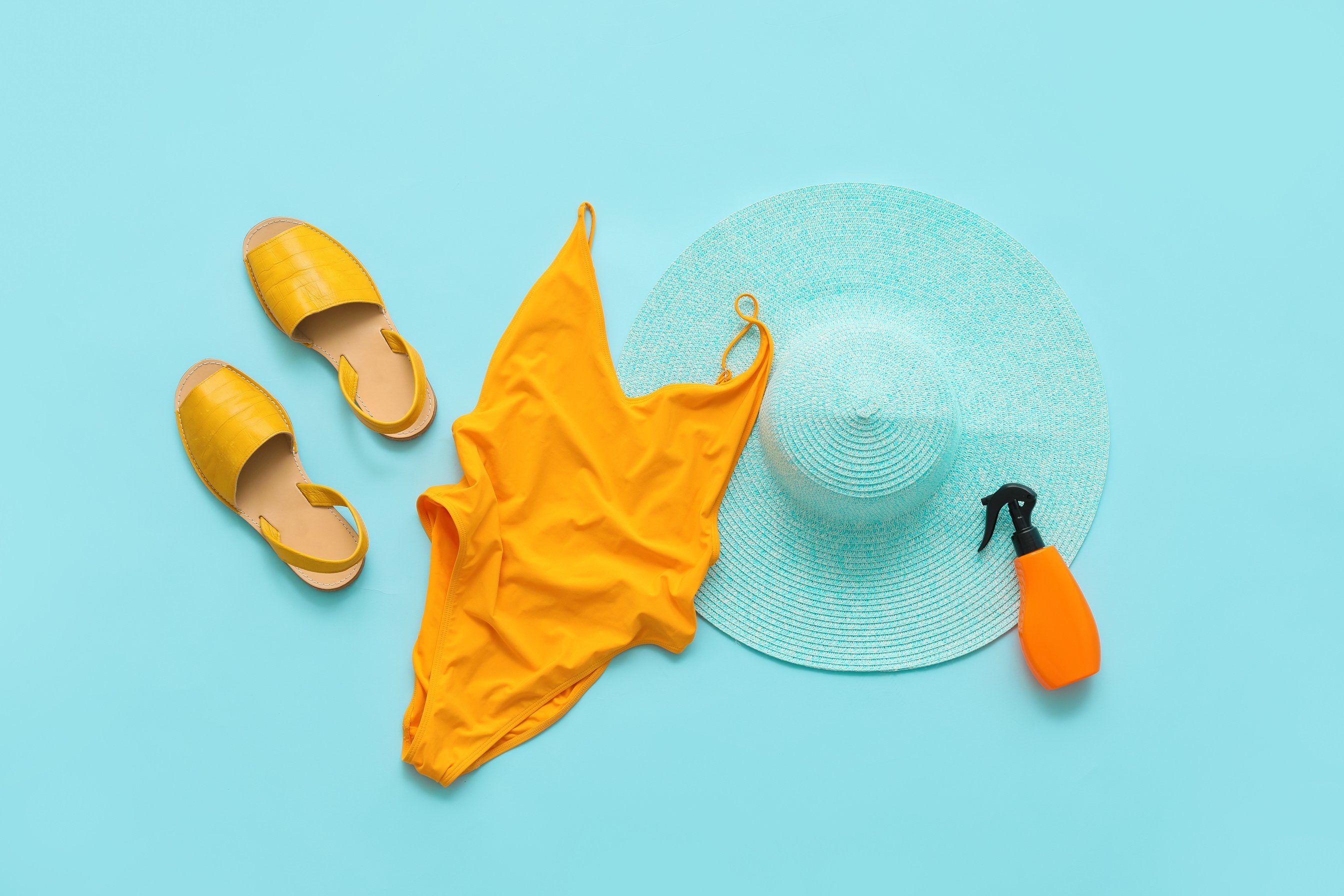 Female Beach Clothes and Accessories on Color Background